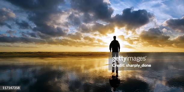 xl solitude beach silhouette - prayer solitude stock pictures, royalty-free photos & images