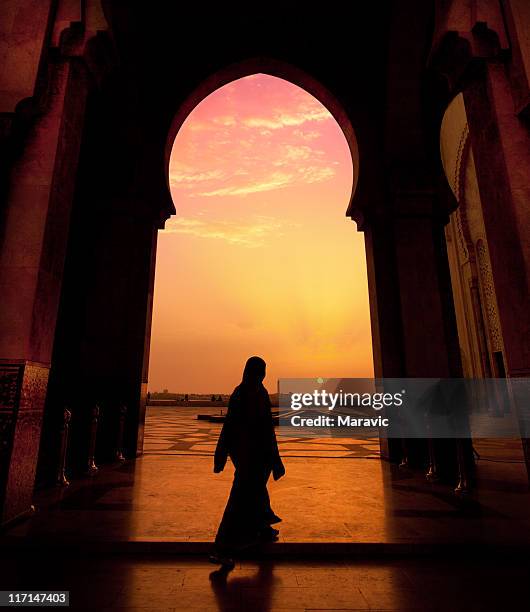 a man walking in a mosque during a sunset - casablanca morocco 個照片及圖片檔