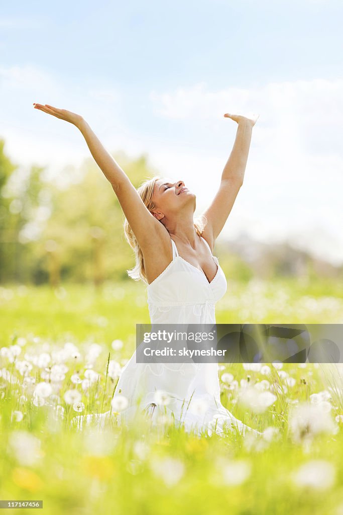 Woman with open hands relaxing on a sun day.