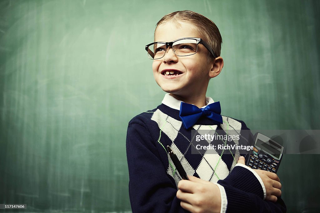 Young Boy Dressed as Nerd Smiles in Classroom