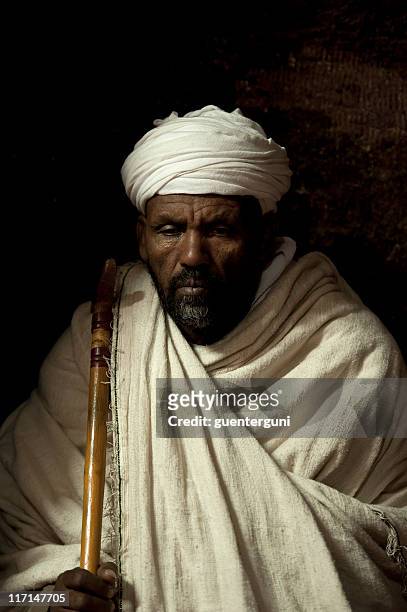 priest inside a rock hewn church in lalibela, ethiopia - ethiopian orthodox church stock pictures, royalty-free photos & images