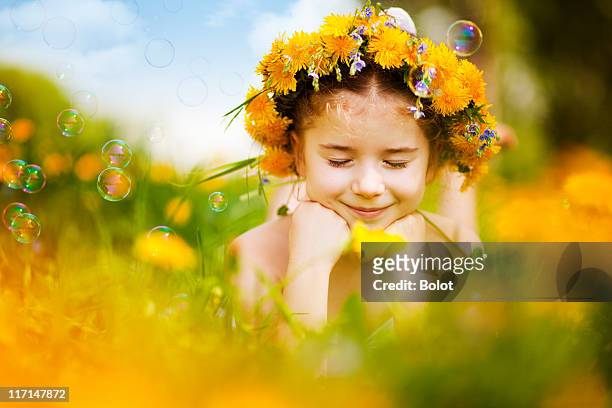 little girl lying on dandelion field - floral wreath bildbanksfoton och bilder