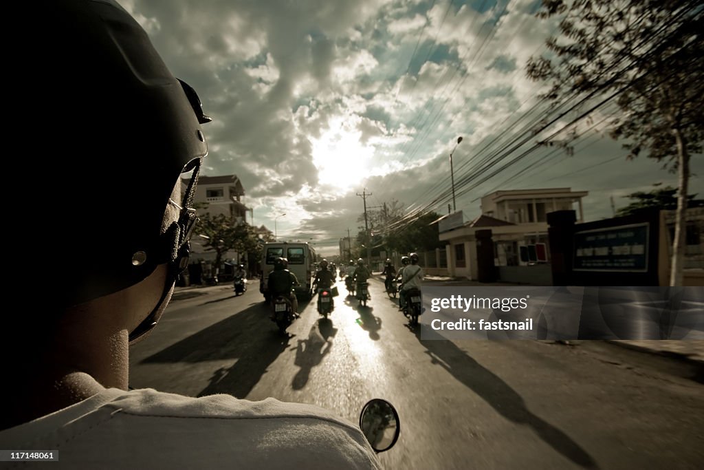 Motobike view from the back on road and sky