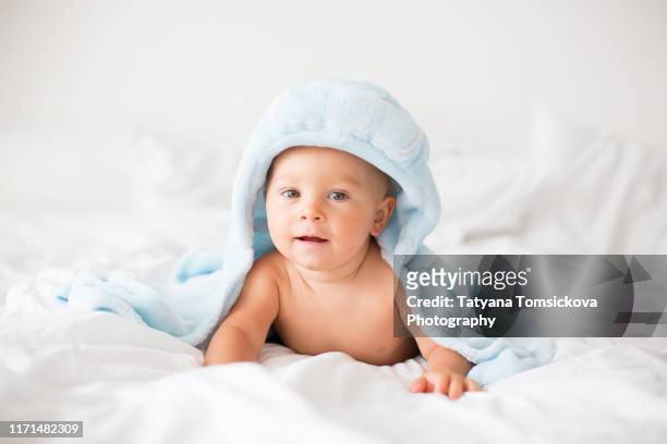 cute baby boy, child after bath with towel on head - taking a bath stock-fotos und bilder