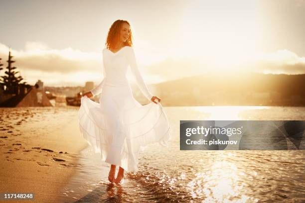 young woman walking on beach - white dress stock pictures, royalty-free photos & images