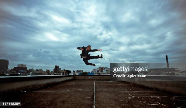 japanese businessman doing a flying kick - ninja stock pictures, royalty-free photos & images