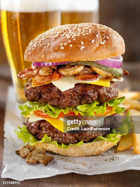 really big burger with a beer - large cucumber stockfoto's en -beelden