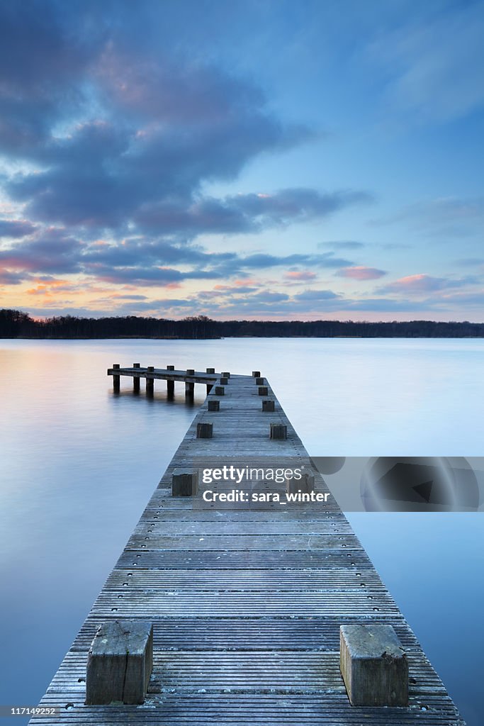 Jetty on lake at sunset in Amsterdamse Bos, The Netherlands