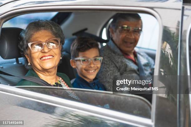grandparents enjoying road trip with their grandson - taxi boys stock pictures, royalty-free photos & images