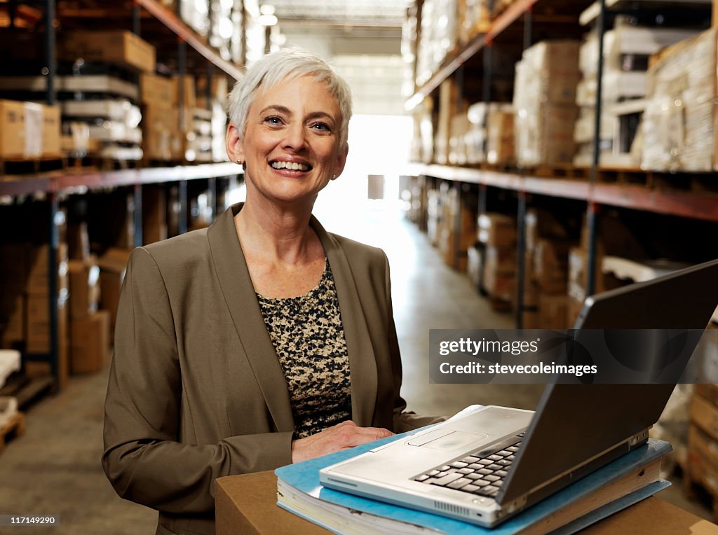 Portrait of Warehouse Businesswoman Smiling