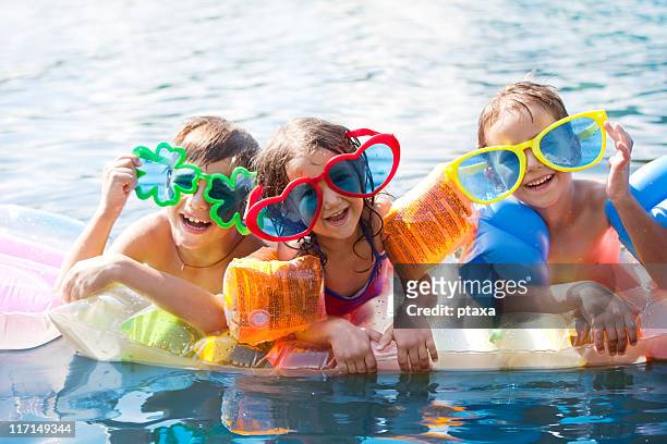 three happy children - arm floats stock pictures, royalty-free photos & images
