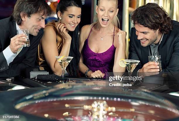 friends plays in the casino on electronic roulette - casino elegance stock pictures, royalty-free photos & images