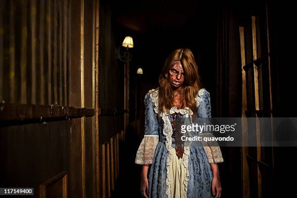 demon young woman wearing period dress, halloween haunted house hallway - period costume stock pictures, royalty-free photos & images