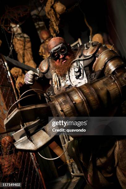 cyborg monster with mechanical arm costume in haunted house - robot human arm stock pictures, royalty-free photos & images