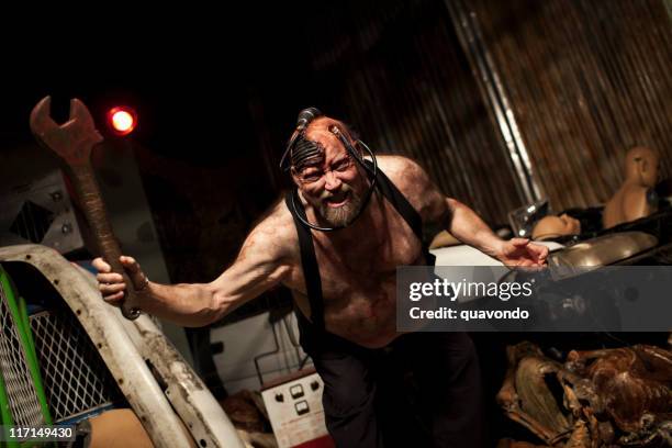 cyborg man in haunted house junkyard holding wrench, copy space - junkyard cyborg stock pictures, royalty-free photos & images