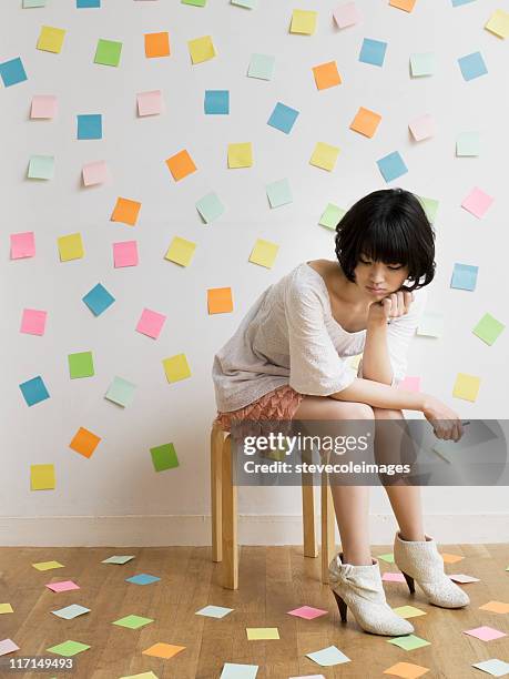 young woman overwhelmed with sticky notes - clutter stock pictures, royalty-free photos & images