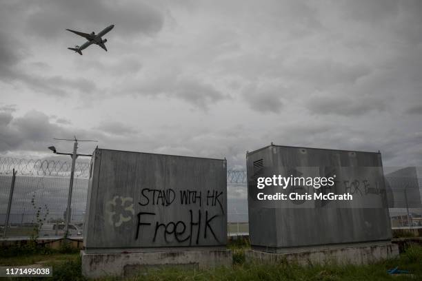 Free HK graffiti is seen as a plane takes off from Hong Kong International Airport on September 1, 2019 in Hong Kong, China. Pro-democracy protesters...