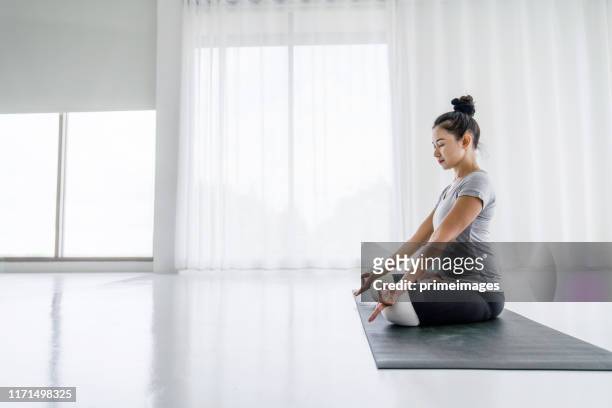 attractive asian women do yoga exercises at home - daily life in philippines stock pictures, royalty-free photos & images
