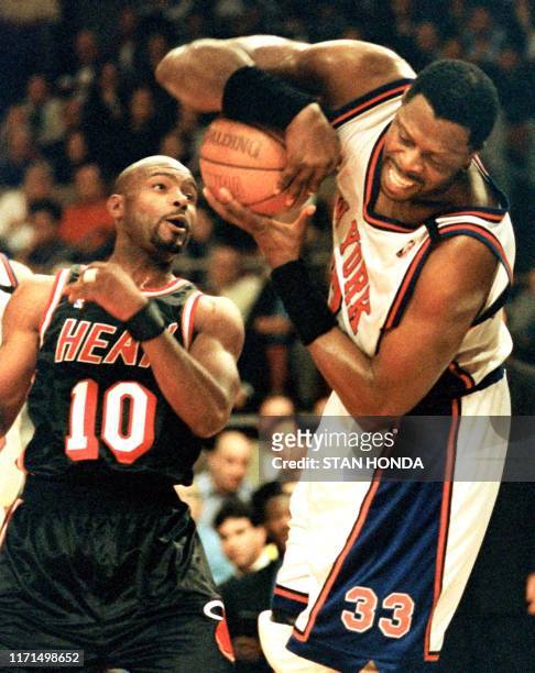 Patrick Ewing of the New York Knicks struggles with a rebound as Tim Hardaway of the Miami Heat defends in the first quarter of the fourth game of...