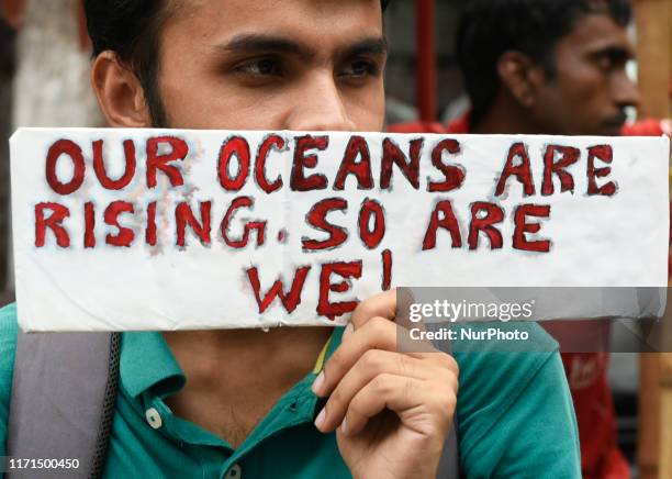 School students, Local Citizens, Environmental Activists shout slogans as they participate in a global climate strike to protest against governmental...
