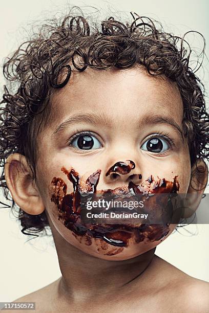 baby with face covered in chocolate - chocolate face stock pictures, royalty-free photos & images