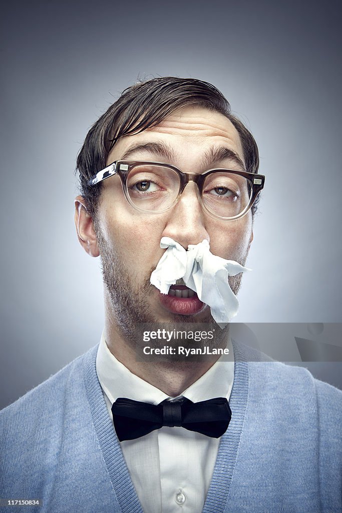 Nerd with a Cold and Tissue in Nose