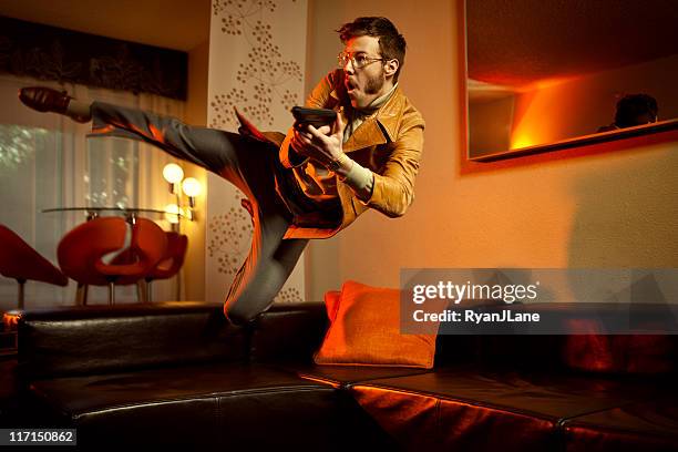 retro secret agent man diving over couch - 70s retro guy stock pictures, royalty-free photos & images