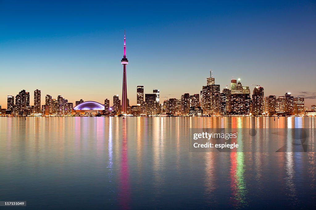 Illuminated Toronto skyline as seen from across the water