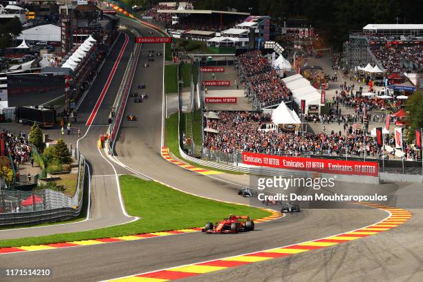 Charles Leclerc of Monaco driving the Scuderia Ferrari SF90 leads the field into up Eau Rouge at the start during the F1 Grand Prix of Belgium at...