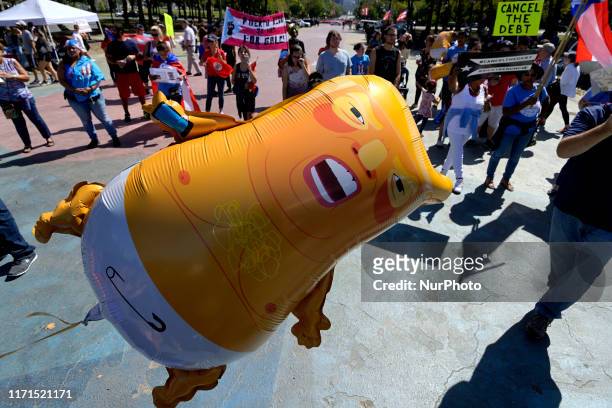 Mini version of the Baby Trump balloon is seen at the Peoples March for Puerto Rico, commemorating the second anniversary of Hurricane Marina, at a...