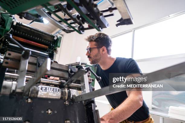 offset printer man with 2 colors printer - offset printer stock pictures, royalty-free photos & images