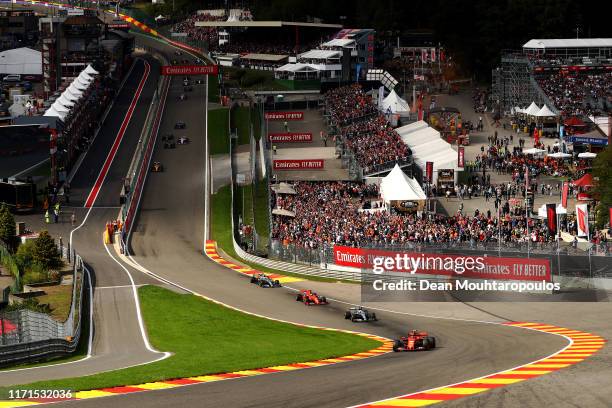 Charles Leclerc of Monaco driving the Scuderia Ferrari SF90 leads the field up Eau Rouge - Raidillon at the start during the F1 Grand Prix of Belgium...