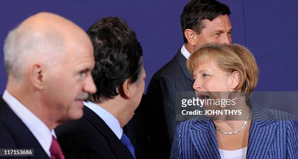 German Chancellor Angela Merkel jokes with Greek Prime Minister George Papandreou and European Commission President Jose Manuel Barroso as they take...