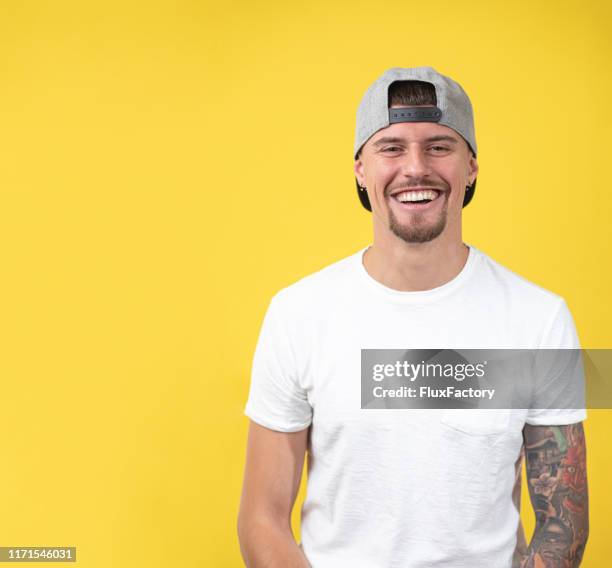toothy smiling model looking at the camera - male model facial expression stock pictures, royalty-free photos & images
