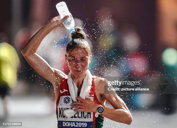 September 2019, Qatar, Doha: Athletics, World Championships, Marathon, Women. Svetlana Kudzelich from Belarus tips a water bottle over her head....