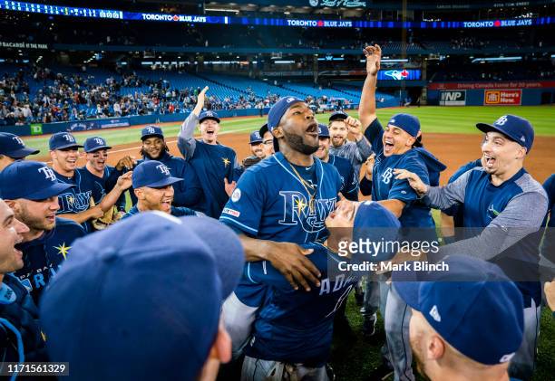 Tampa Bay Rays players celebrate clinching a wild card playoff spot after defeating the Toronto Blue Jays in their MLB game at the Rogers Centre on...