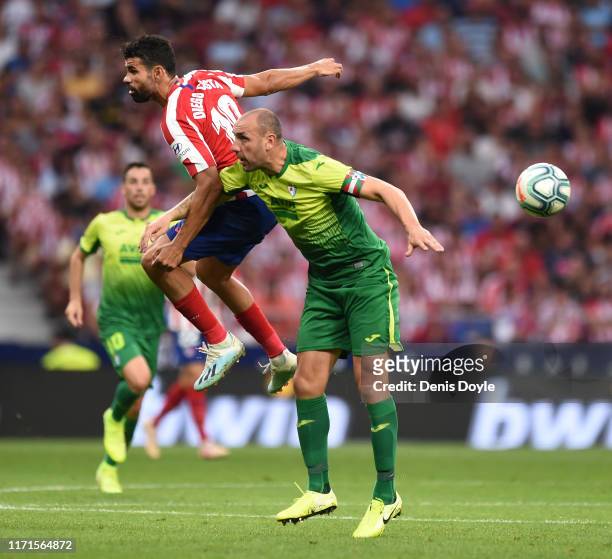 Diego Costa of Atletico Madrid battles for possession with Ivan Ramis of SD Eibar during the Liga match between Club Atletico de Madrid and SD Eibar...