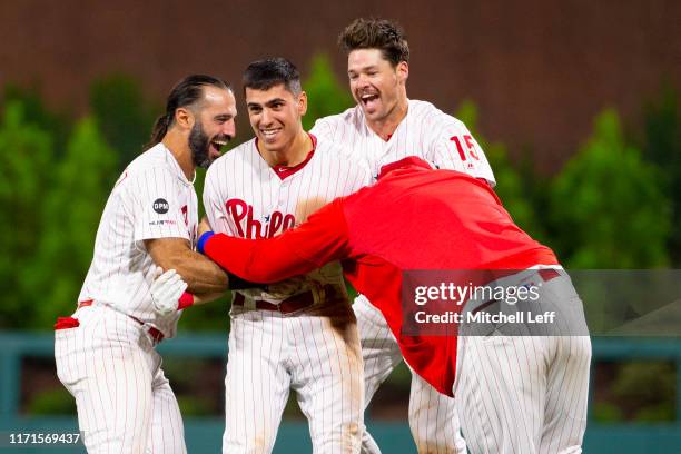 Adam Haseley of the Philadelphia Phillies celebrates with Sean Rodriguez, Andrew Knapp, and Logan Morrison after hitting a game winning fielders...