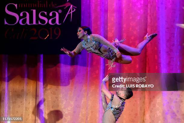 Colombian salsa dancers Jenifer Florez and John Herrera participate in the couple salsa cabaret professional category during the 14th World Salsa...