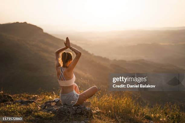 teen. beautiful teenage girl doing yoga exercises outdoors in the nature. lotus position - yoga day stock pictures, royalty-free photos & images