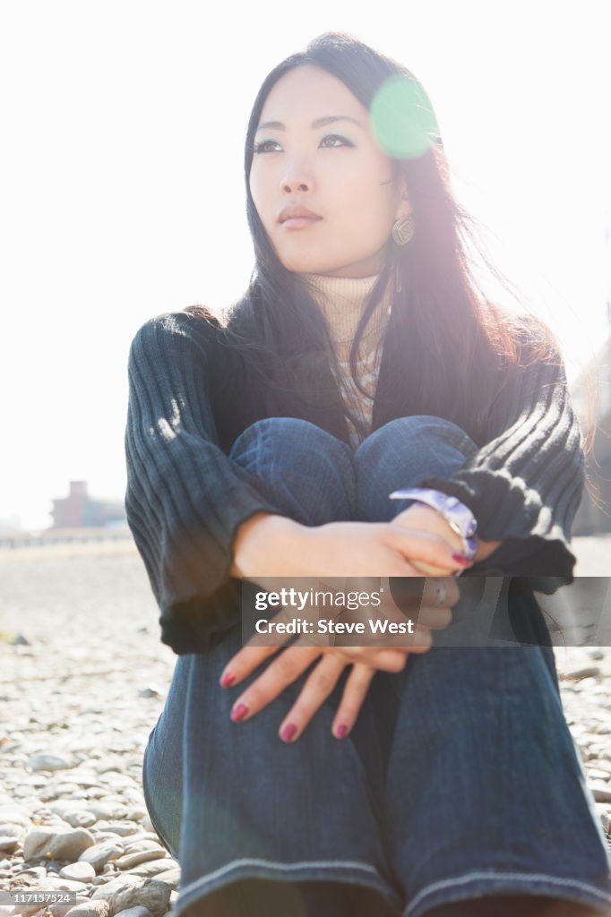 Beautiful Asian woman sitting contemplating