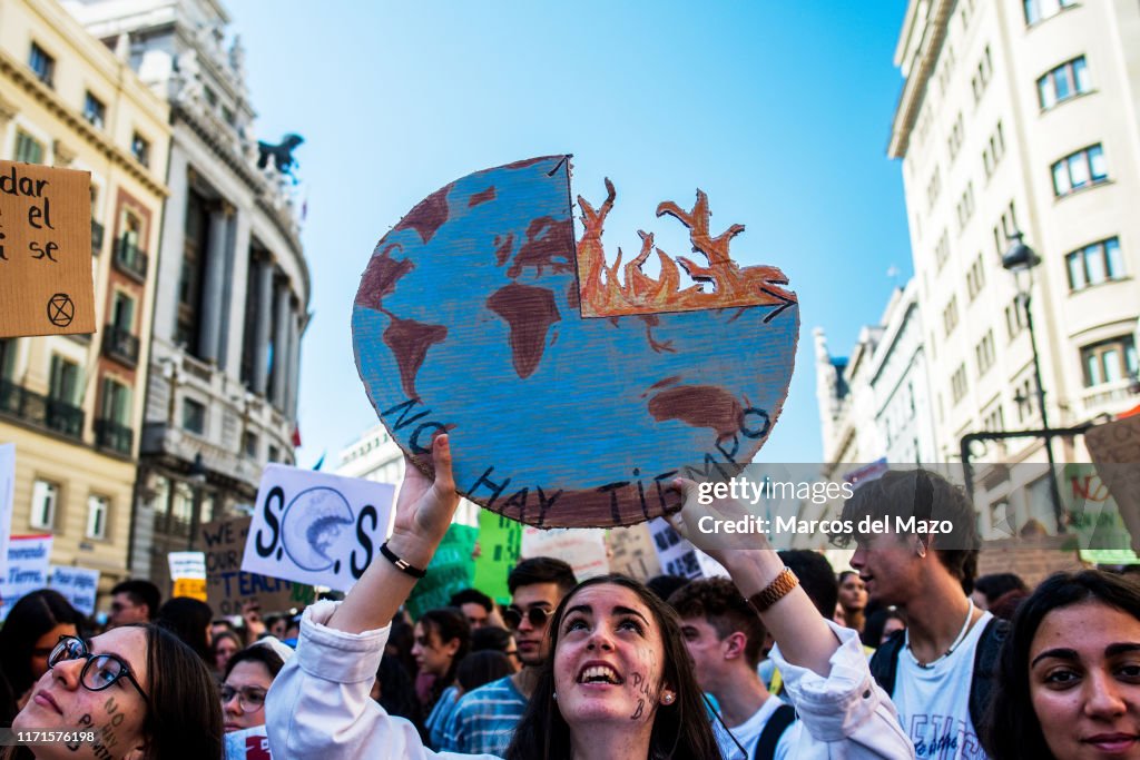 A student with a placard with the earth burning, protesting...