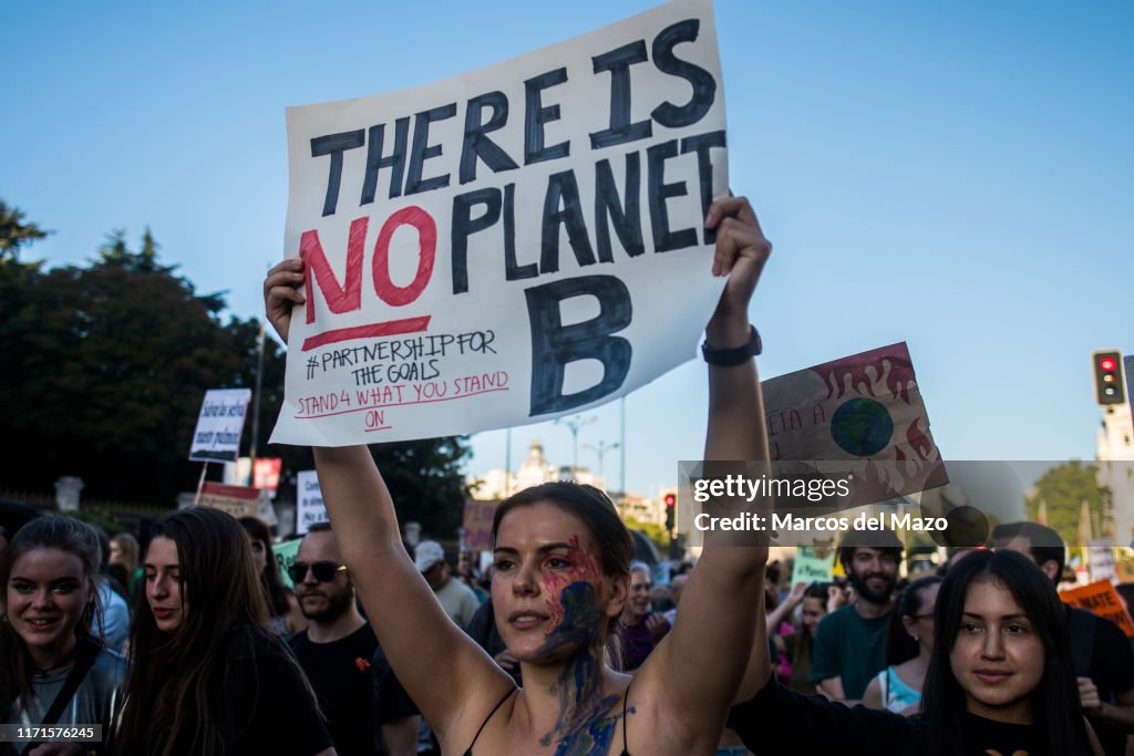 Face Protesting A woman with her face painted protesting with a placard during a ...