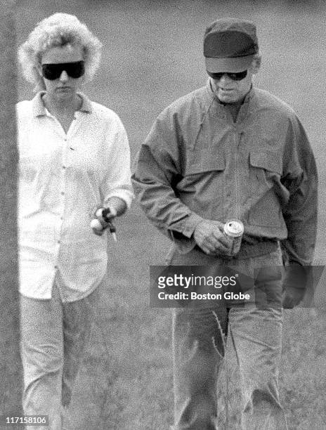 James "Whitey" Bulger and Catherine Greig walk together.