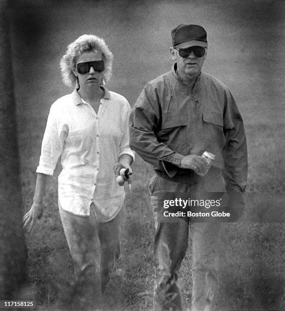 James "Whitey" Bulger and Catherine Greig walk together.