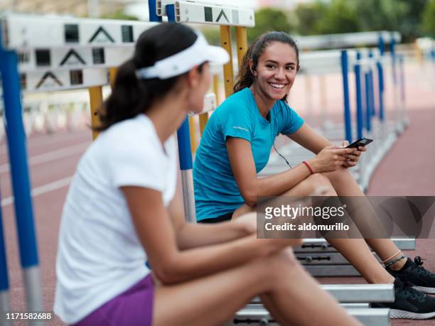 female athletes taking a break - university athletics stock pictures, royalty-free photos & images