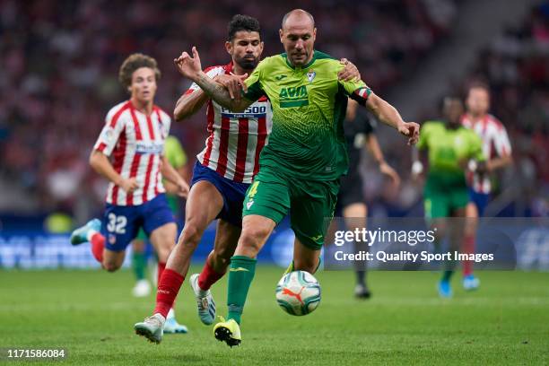 Diego Costa of Atletico de Madrid battles for the ball with Ivan Ramis Barrios of SD Eibar during the La Liga match between Club Atletico de Madrid...