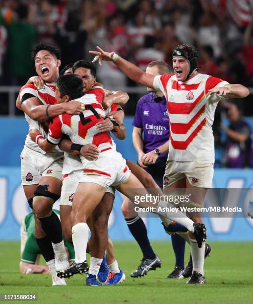 Japan's Kazuki Himeno celebrates with Shunsuke Nunomaki at the final whistle after their 19-12 victory in the Rugby World Cup 2019 Group A game...