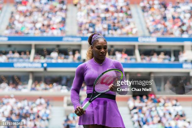 Serena Williams of the United States checks her racket during her fourth round Women's Singles match against Petra Martic of Croatia on day seven of...