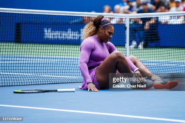 Serena Williams of the United States takes a fall during her fourth round Women's Singles match against Petra Martic of Croatia on day seven of the...